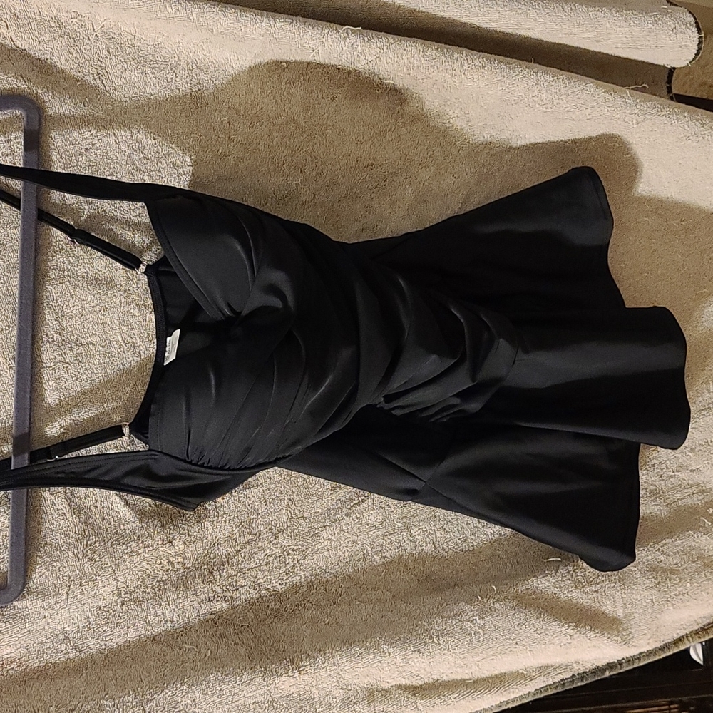 NEVER WORN.  VENUS Swimwear one piece with ruched front and skirt..